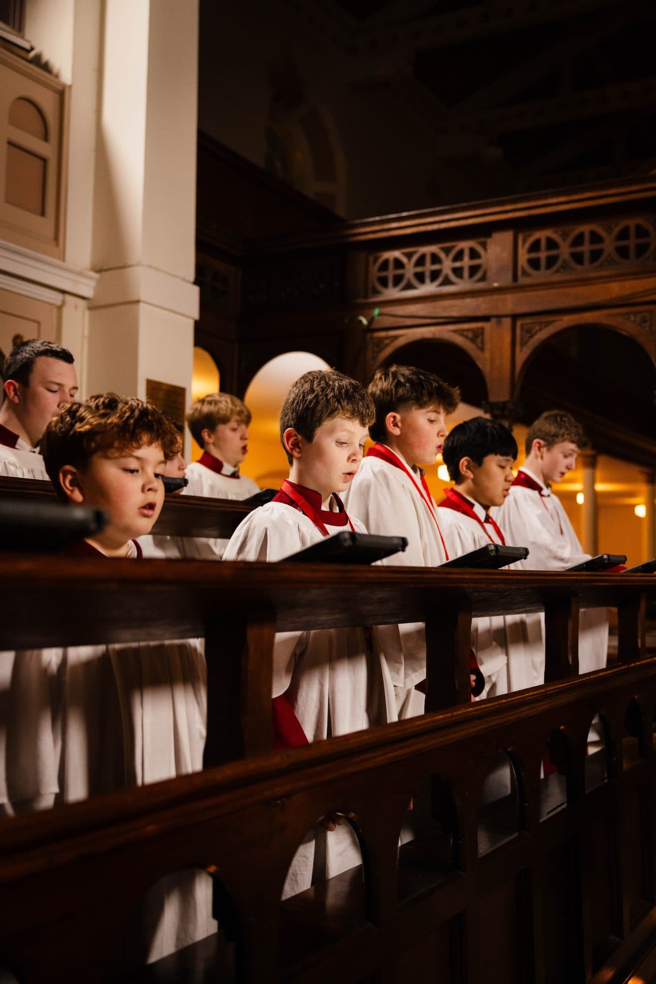 Boy choristers of the Parish Choir singing in the choir stalls